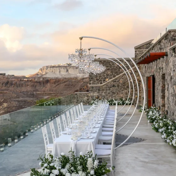 Luxury wedding lighting design with multiple chandeliers at Cavo Ventus Santorini Greece