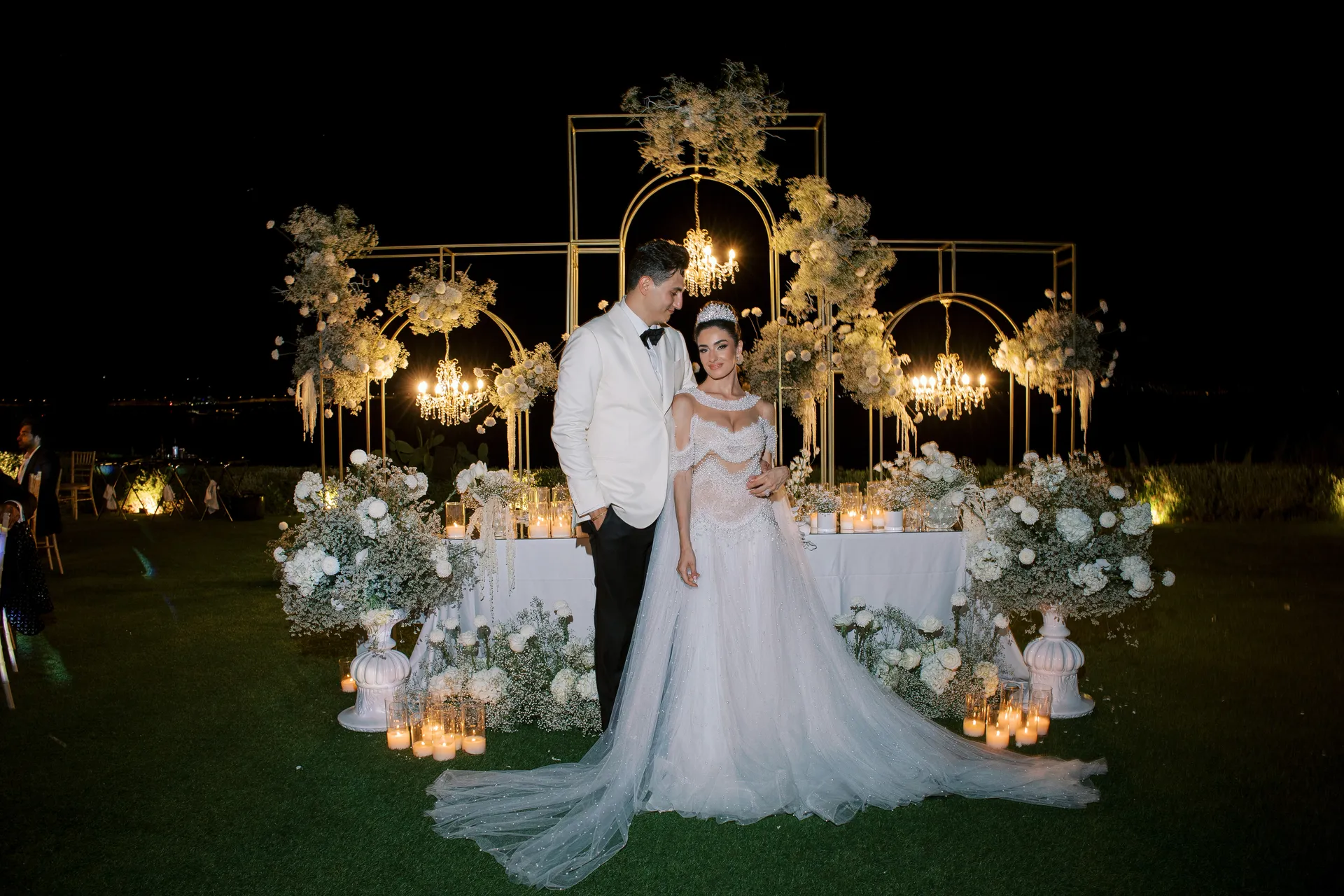 Romantic wedding reception illuminated by luxury crystal chandeliers