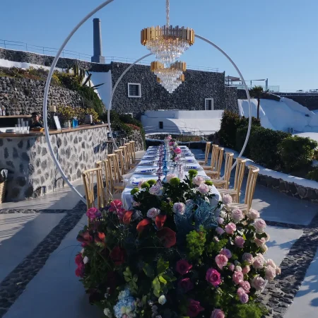 Katarina crystal chandelier above a long outdoor wedding table in Santorini, Greece